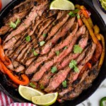 Overhead photo of Steak Fajitas in a cast iron skillet.