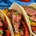 close up of three steak fajitas in tortilla shells