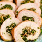 a close up of a piece of stuffed pork tenderloin that has been cooked and sliced, with mushrooms and spinach in the middle - 9