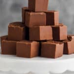 a pile of three ingredient fudge on a cake stand