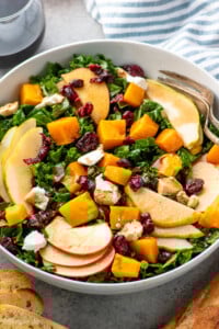 Bowl of Winter Salad topped with cranberries and goat cheese. - 8