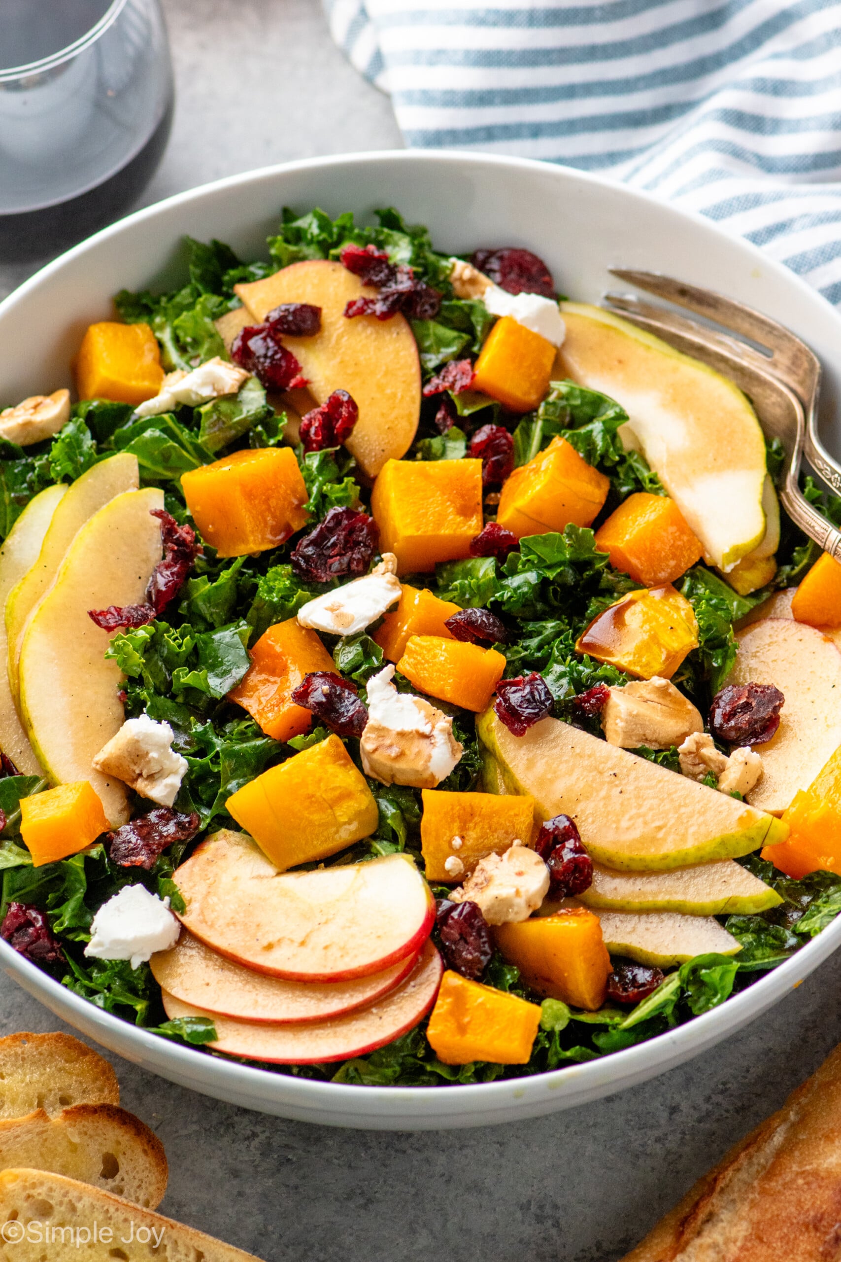Bowl of Winter Salad topped with cranberries and goat cheese.