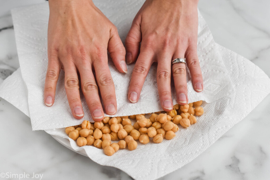drying off chickpeas with a paper towel