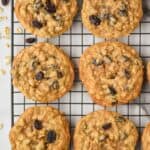 overhead view of six oatmeal raisin cookies on a wire cooling rack on a marble countertop - 17