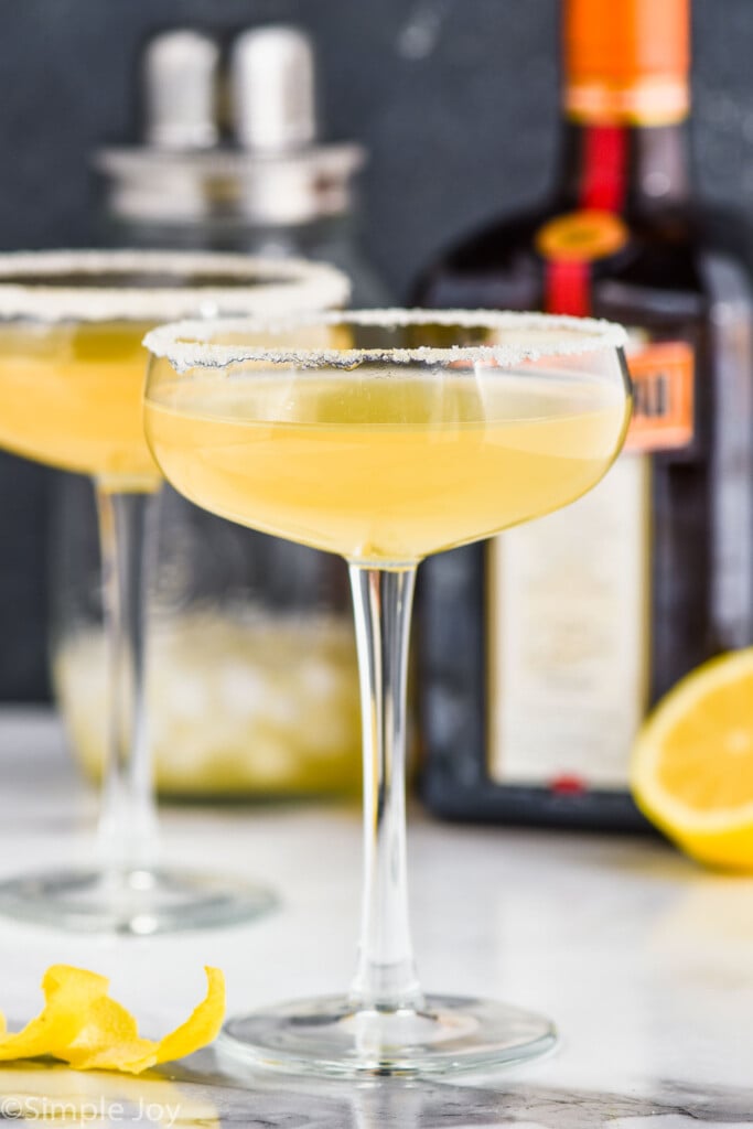 two coupe glasses, both rimmed with sugar holding a sidecar drink