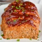 front view of a ground turkey meatloaf that has been sliced into and looks super moist - 8