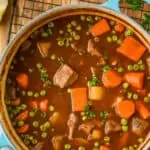 overhead view of a teal dutch oven holding beef stew