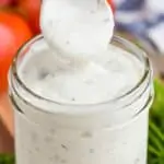 small wooden spoon lifting out of a mason jar of ranch dressing