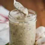 a spoonful of homemade condensed cream of mushroom soup dripping into the jar