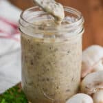 a spoonful of homemade condensed cream of mushroom soup dripping into the jar