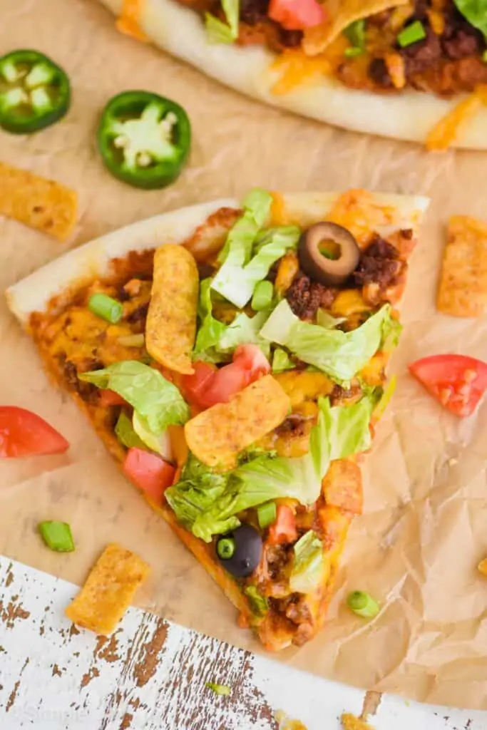 once slice of taco pizza on brown parchment paper