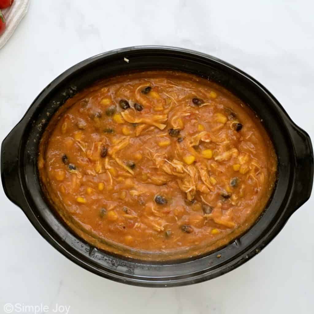 Overhead of slow cooker of chicken enchilada soup