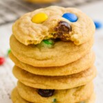 stack of M&M cookies recipe with the top cookie missing a bite - 8