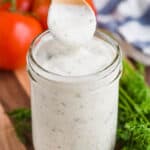 small wooden spoon lifting out of a mason jar of ranch dressing