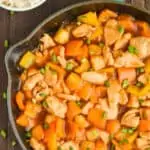 close up overhead overhead Hawaiian chicken recipe in a skillet garnished with green onions