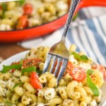 pinterest graphic of a plate of chicken pesto pasta with a fork digging in, says: "30 minute chicken pesto pasta simplejoy.com"