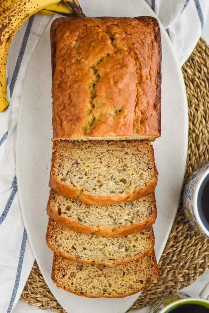 overhead view of banana bread recipe, the first half of the loaf has been sliced