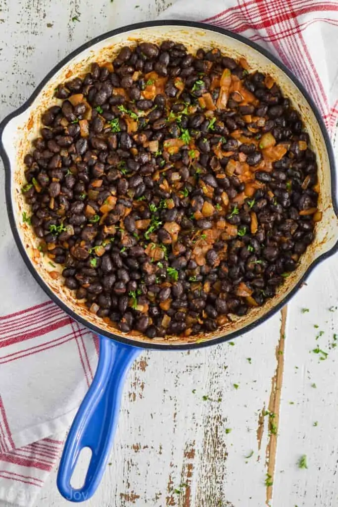 A overhead photo of a cast iron skillet filled with the black bean filling