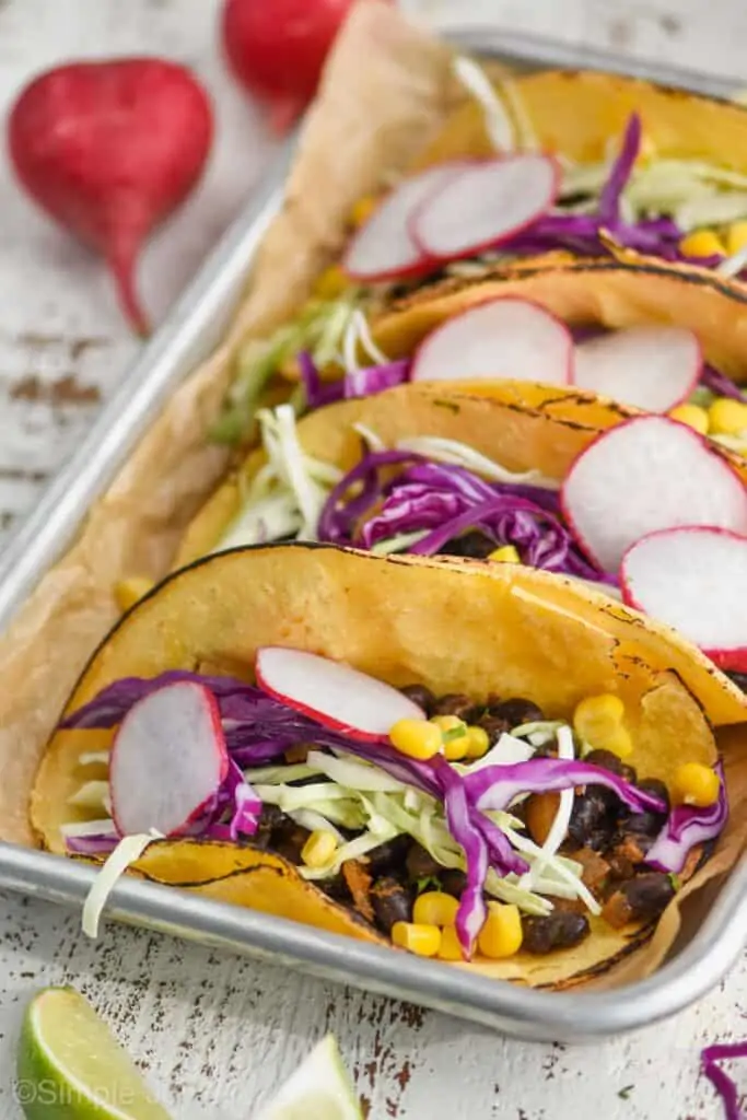 up close of a vegan black bean taco from the side in a corn tortilla