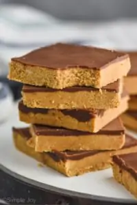 stack of five peanut butter chocolate bars, top one has a bite out of it