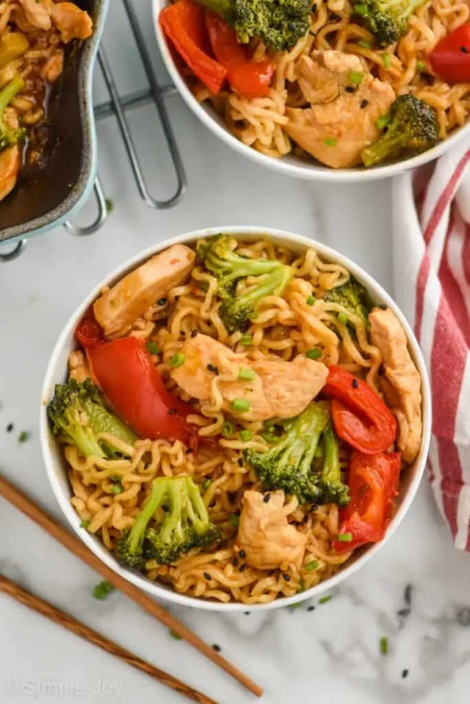 overhead view of ramen noodle stir fry in a white bowl