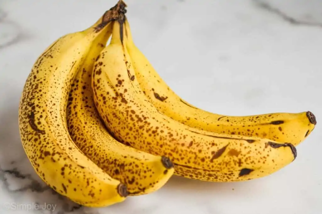 picture of a bunch of banana that are speckled brown and ready to be made into banana bread