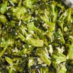 overhead view of parmesan broccoli in a white bowl on a wire rack