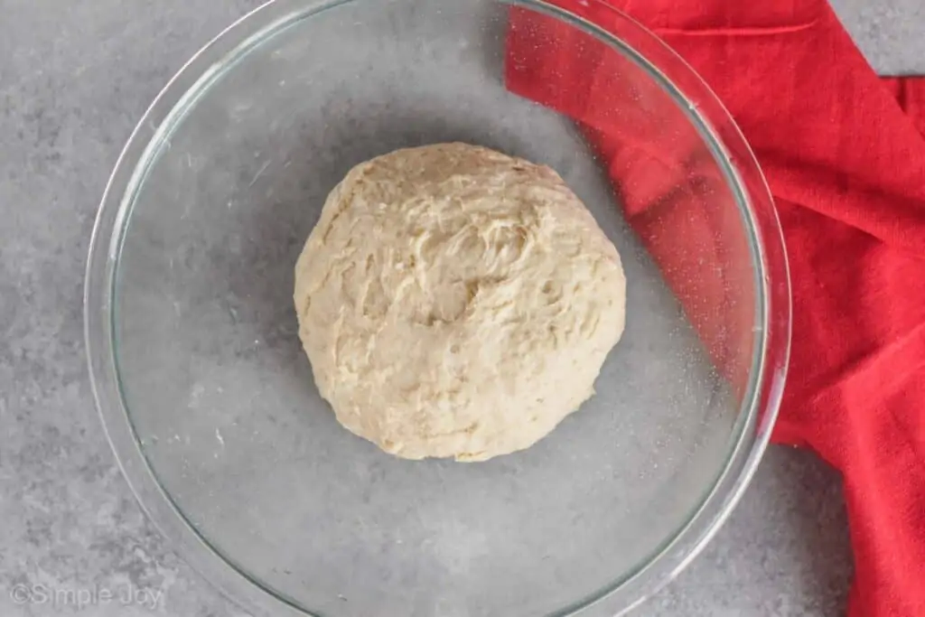 overhead view of sandwich bread dough in a bowl before it has risen