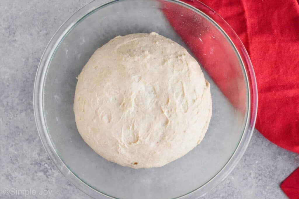 overhead view of a bowl full of risen bread dough