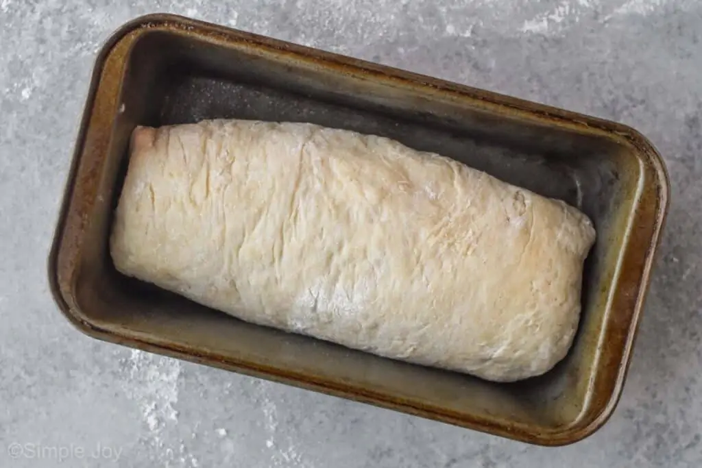 overhead view of uncooked white bread recipe in a loaf pan