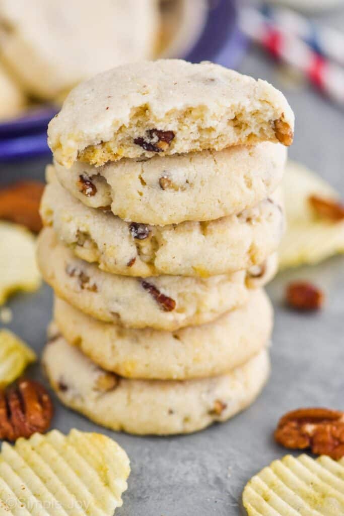 stack of pecan sandies made with potato chips with the top one broken in half