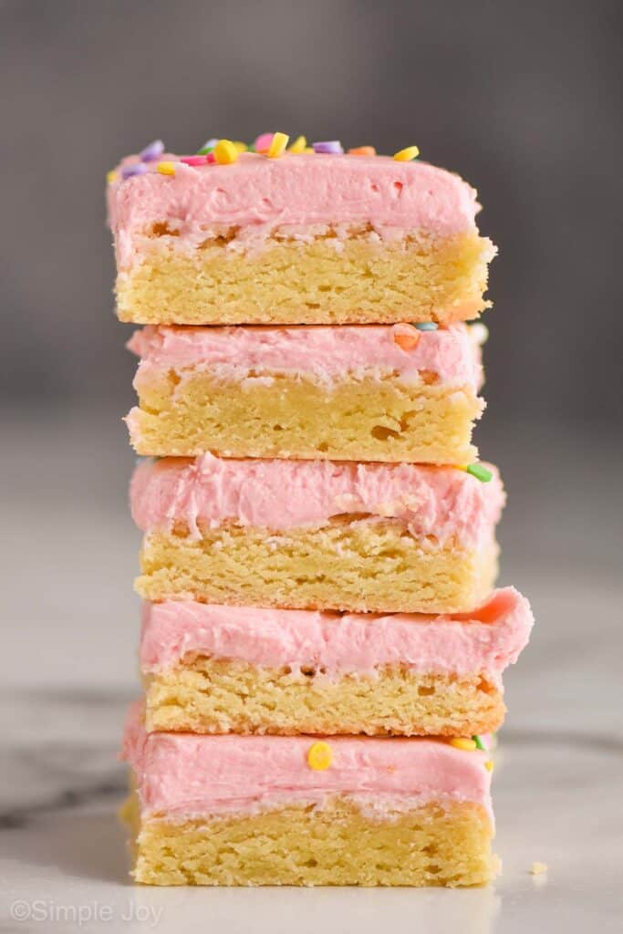 stack of five sugar cookie bars with pink frosting