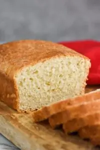 a loaf of sandwich bread cut in the middle with slices coming towards the camera