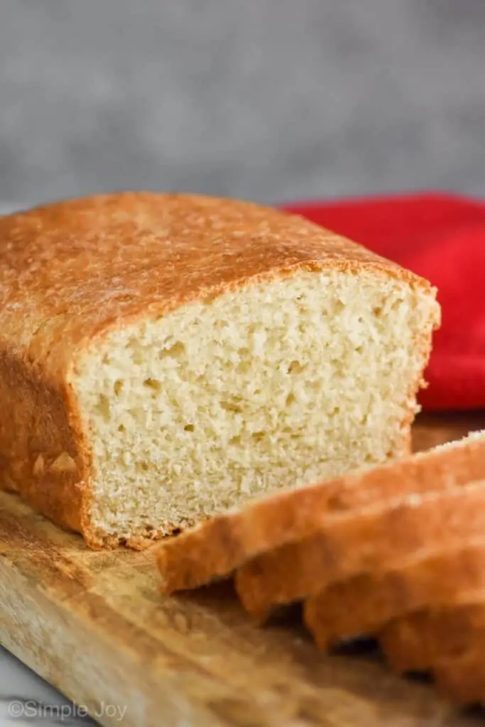 a loaf of sandwich bread cut in the middle with slices coming towards the camera 