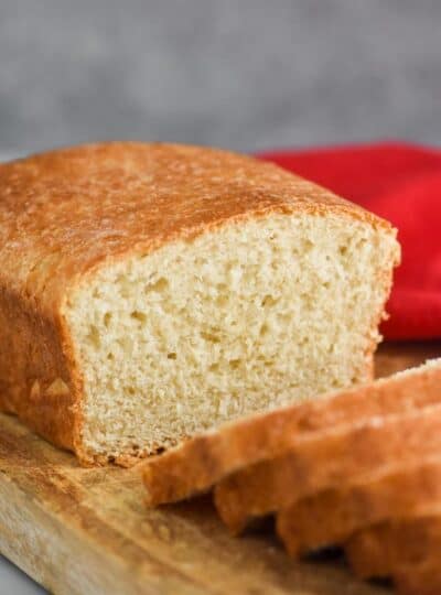 a loaf of sandwich bread cut in the middle with slices coming towards the camera