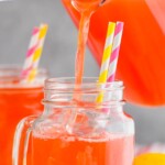 pinterest graphic of strawberry lemonade being poured into a mason jar glass, that says "the best strawberry lemonade simplejoy.com"