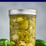 small mason jar filled with pickled jalapeños, yellow green in color and packed in liquid