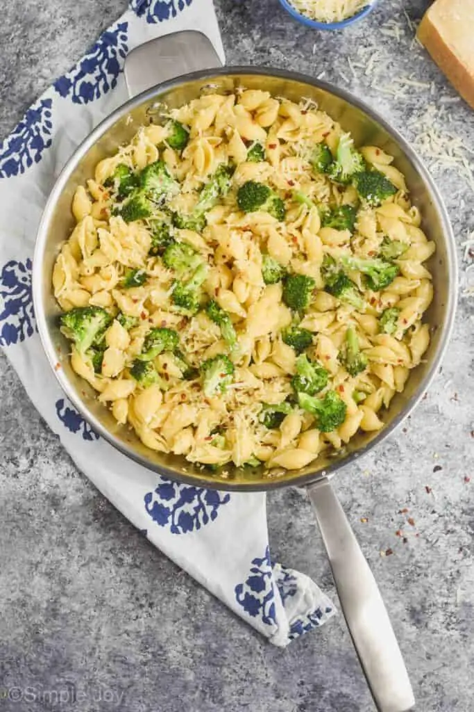 overhead view of a metal skillet holding easy pasta recipe made with shells and broccoli