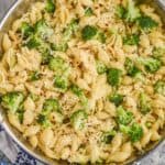 close up overhead view of broccoli pasta recipe made with shells, broccoli florets, red pepper flakes and freshly grated parmesan cheese - 13