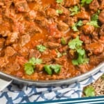 pinterest graphic of the side view of a pan full of beef curry recipe