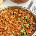 a skillet with beef curry