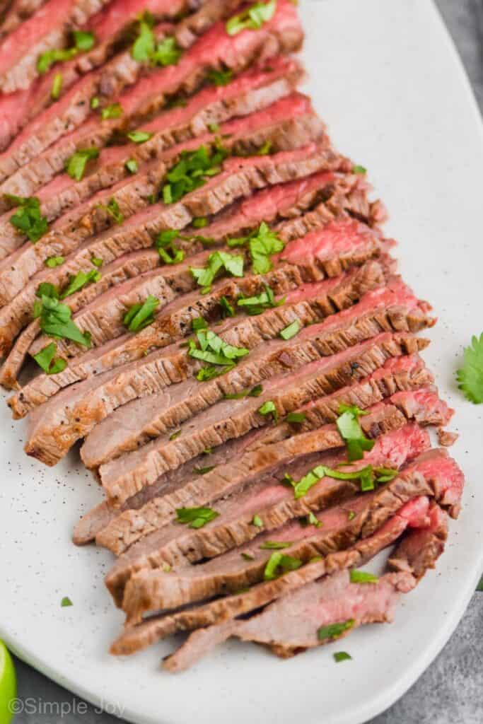 close up of a grilled flank steak recipe with cut up cilantro on top
