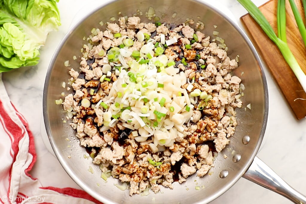 ground meat, sauce, onions, and water chestnuts in a skillet to make chicken lettuce wraps - 5