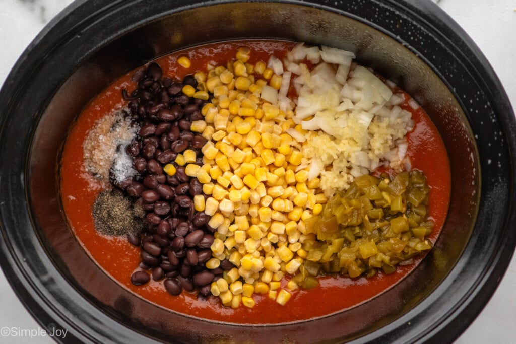 corn, black beans, green chiles, onion, garlic, salt and pepper in a slow cooker with enchilada sauce - 5