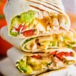 three stacked chicken wraps that have been cut in half and you can see ingredients inside after cooking - 27