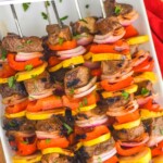 overhead photo of steak kabobs on a plate