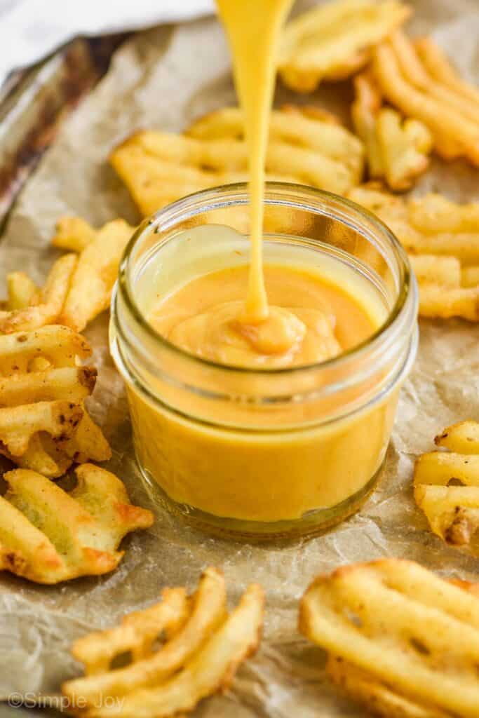 Chick Fil A sauce recipe pouring into a small mason jar
