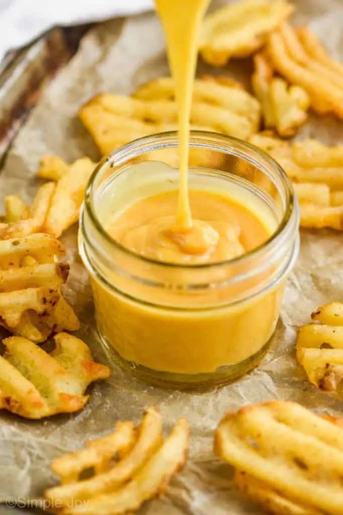 Chick Fil A sauce recipe pouring into a small mason jar