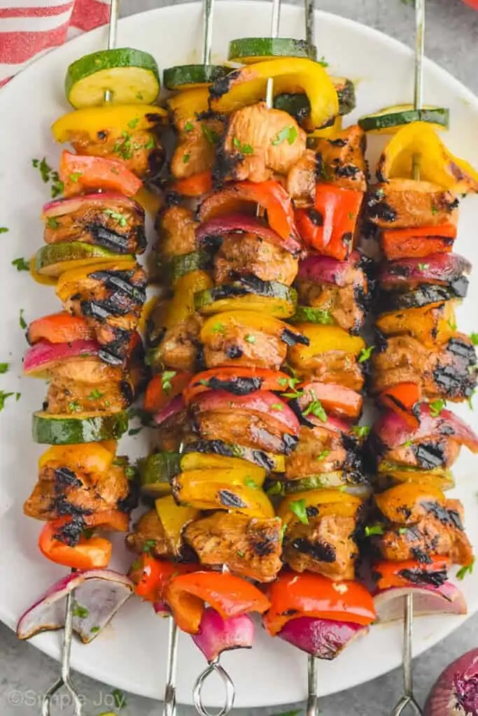 close up of grilled chicken kabobs on a plate