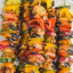 close up of grilled chicken kabobs on a plate